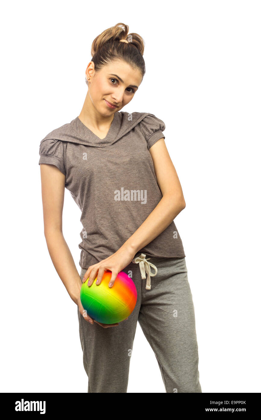 young woman holding in her hands a colorful ball over white background Stock Photo