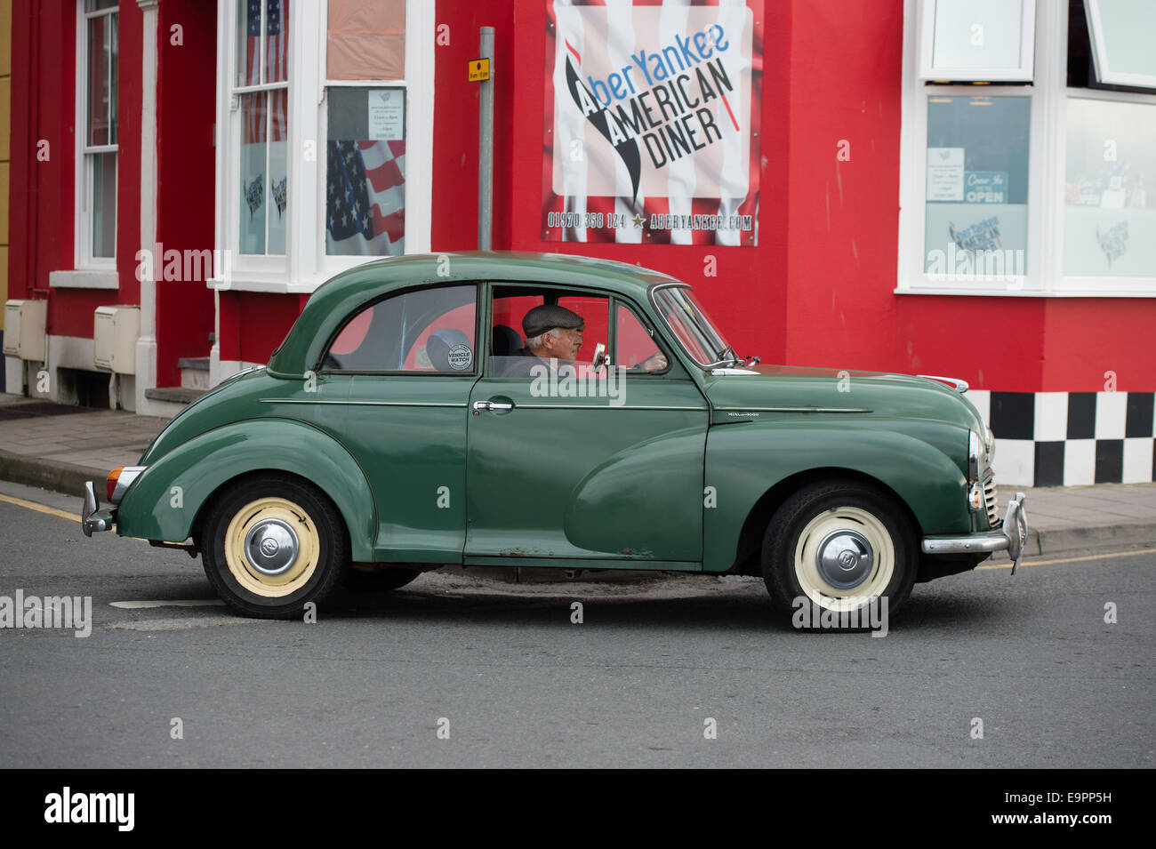 Aberystwyth Wales UK, Friday 31 October 2014  84 year old retired train driver JOHN DAVIES of Aberystwyth UK, with his green  Morris Minor 1000 car, DFF 224C,  as it turns over the 300,000 mile mark on the day before its 49th birthday.   The car was first registered on Nov 1 1965, and has been used by John virtually every day since he got it from his brother in 1984. Credit:  keith morris/Alamy Live News Stock Photo
