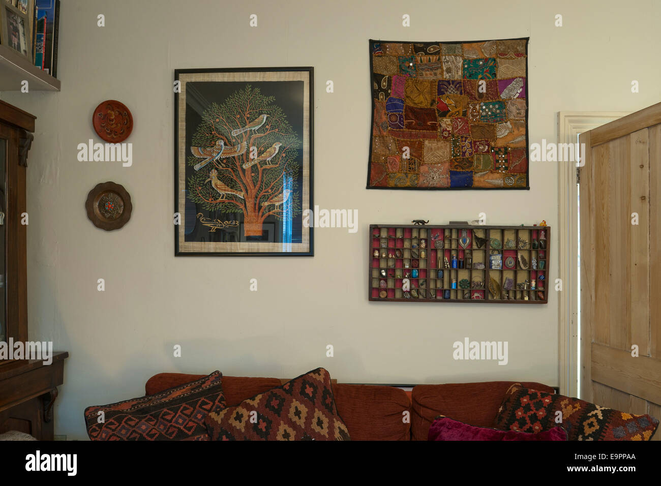 Artwork and wall hangings in living room of renovated terraced house