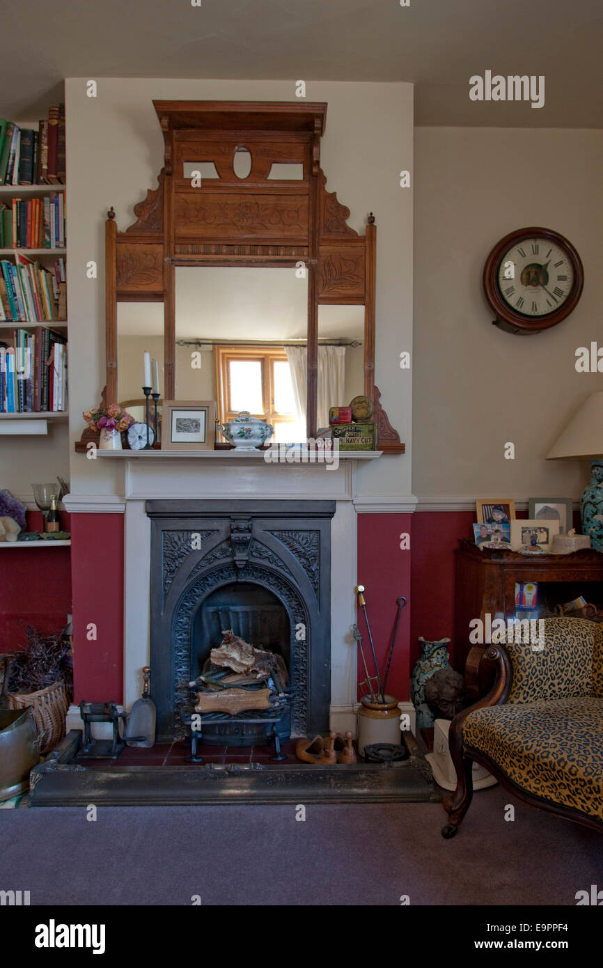 Victorian fireplace and mirrored overmantel in UK home. Stock Photo