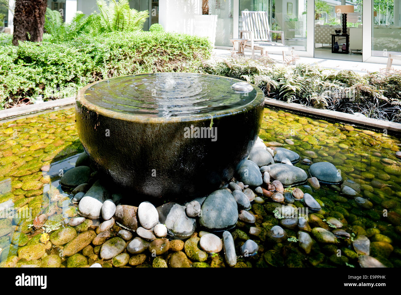 Freestanding water feature surrounded by pebbles, Petersham, England, UK Stock Photo Alamy