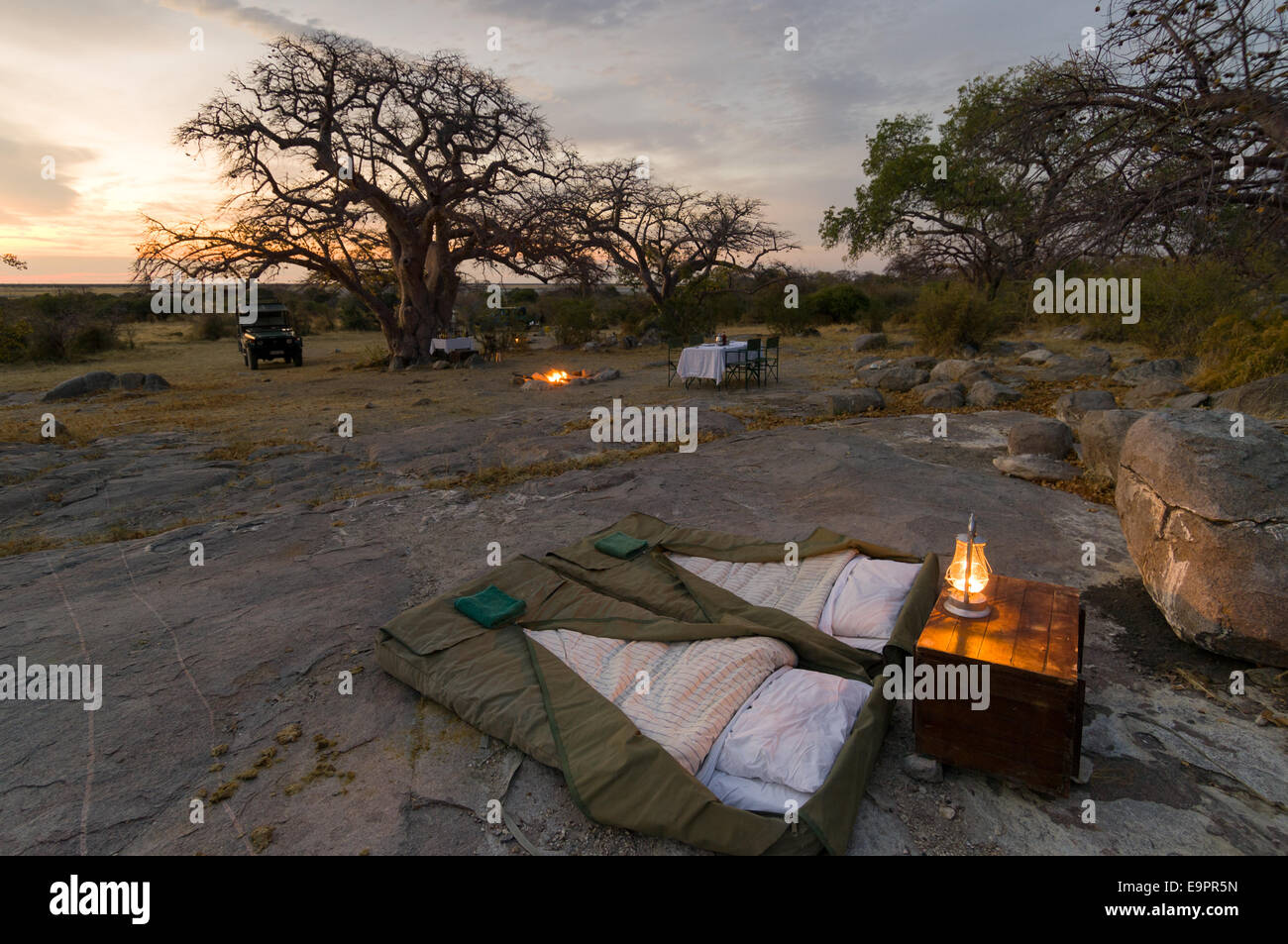 Camping beds of a luxury private safari camp on the granite mass of Kubu Island (Lekhubu) at sunset, Magkadigkadi Pan, Botswana Stock Photo