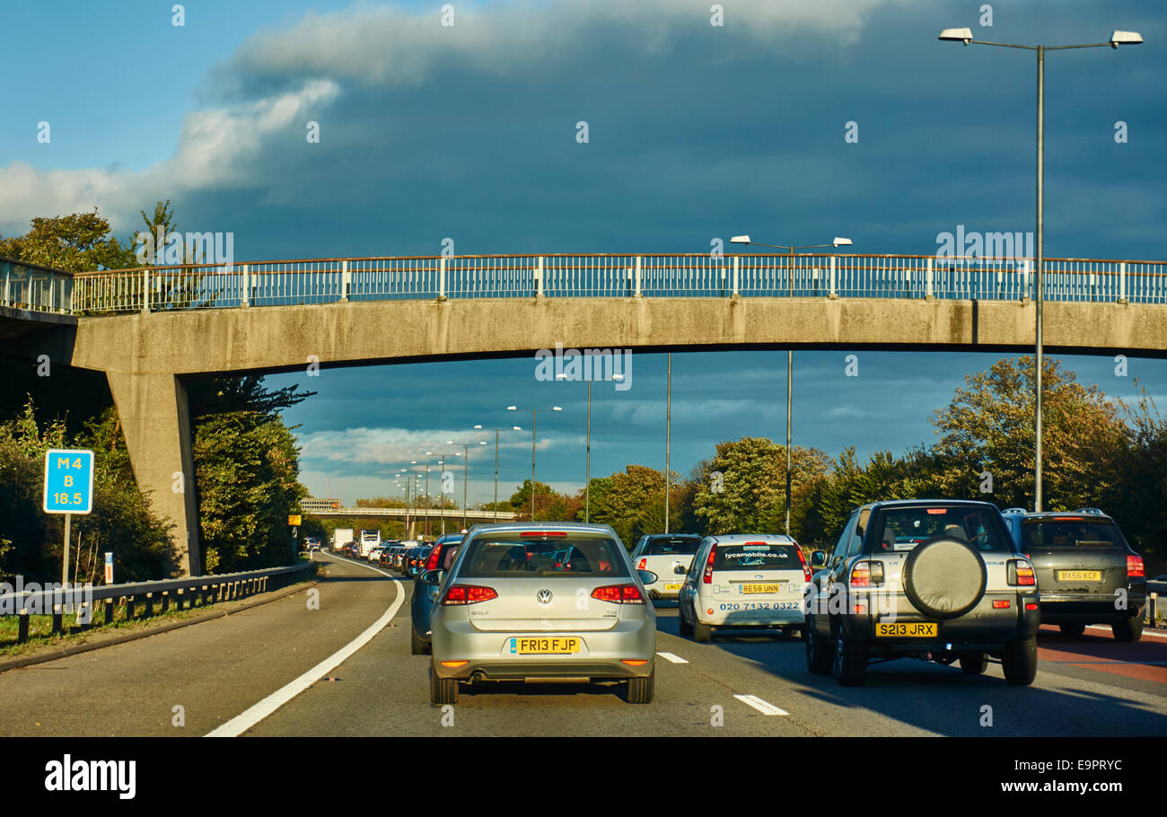 A traffic jam, with vehicles at a standstill in the warm early evening sunshine, on the M4 motorway, West London, England, UK. Stock Photo