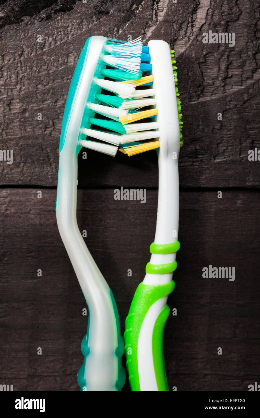 Colorful toothbrushes on black wooden background Stock Photo - Alamy