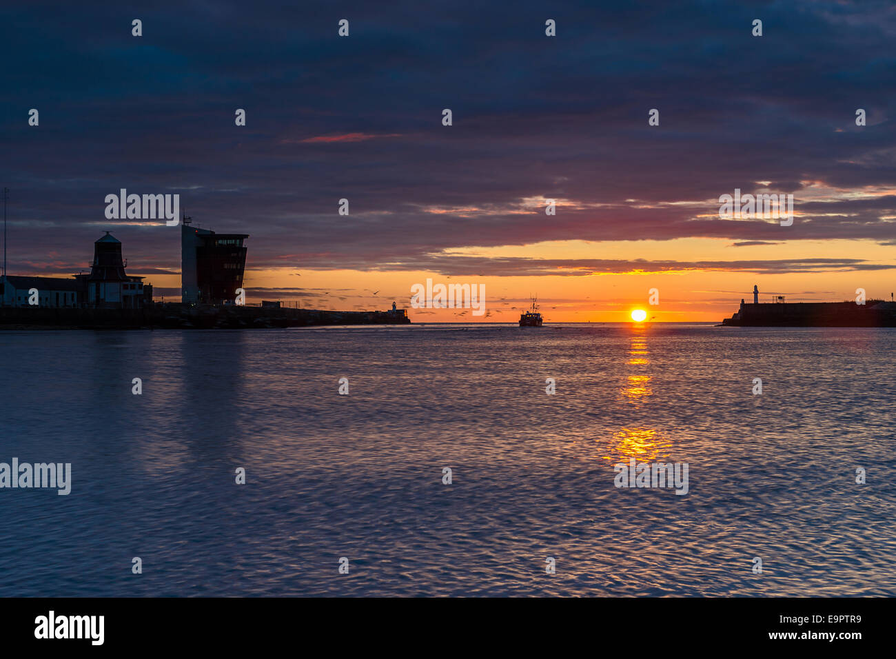 Aberdeen harbor entrance, boat and sunrise Stock Photo Alamy