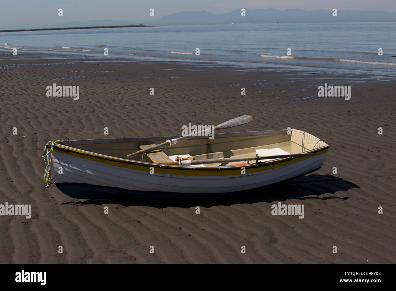 A white rowboat on a sandy shore on Wreck Beach, Vancouver, British Columbia, Canada. Stock Photo