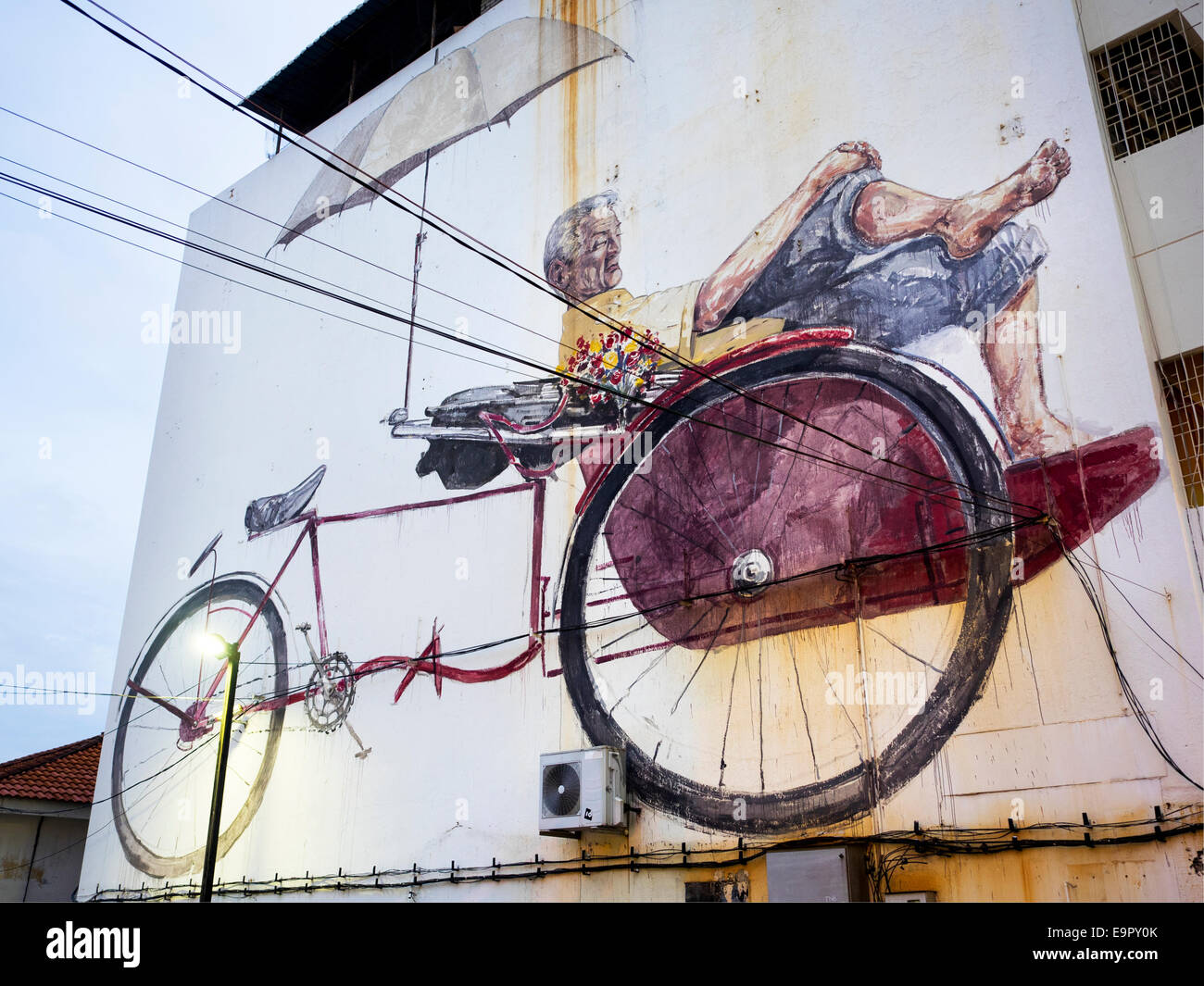 'The Awaiting Trishaw Paddler' street art mural painted by Lithuanian artist Ernest Zacharevic in George Town, Penang, Malaysia. Stock Photo