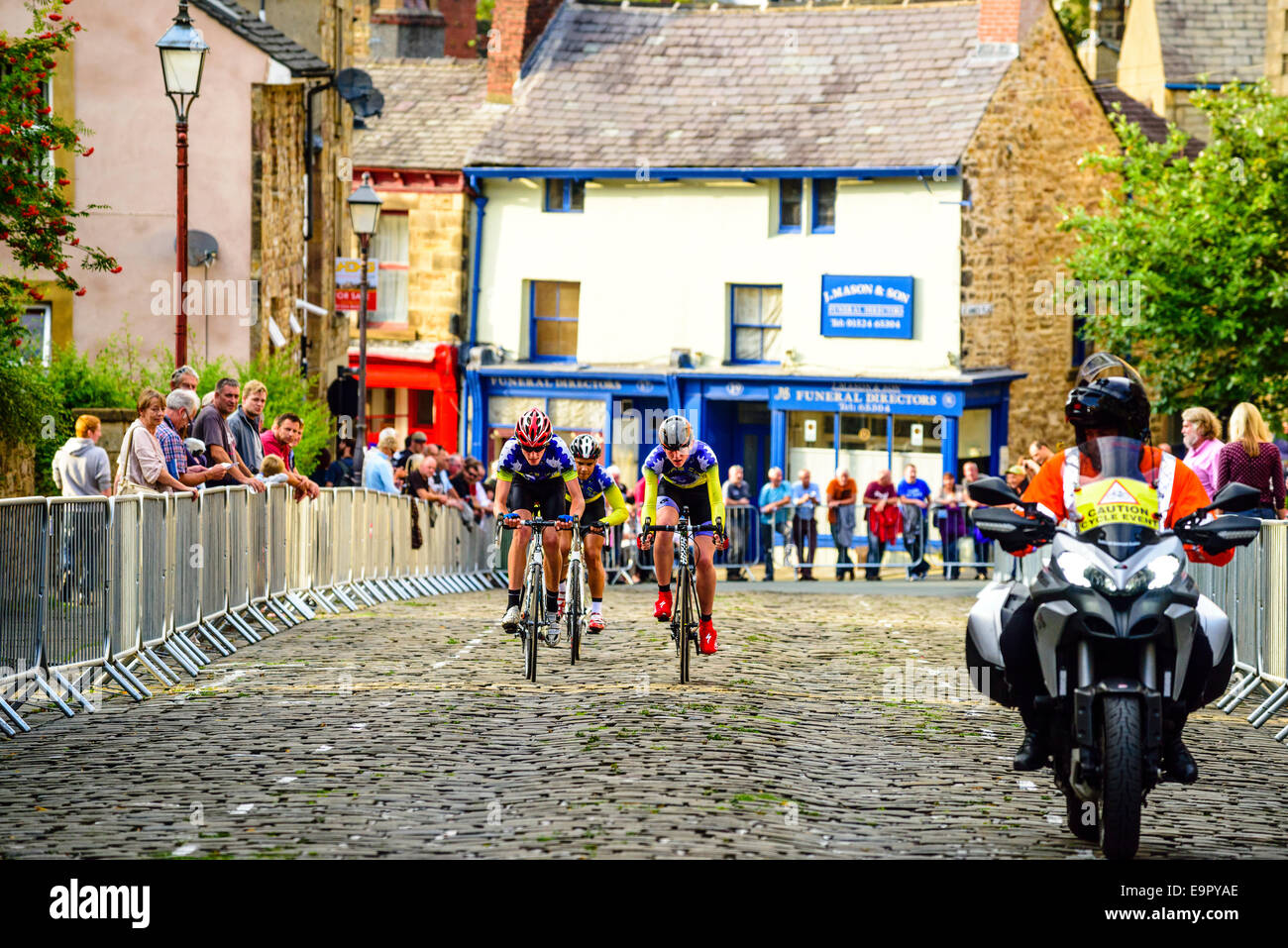 Young cyclists racing in evening criterium event in Lancaster Lancashire England Stock Photo