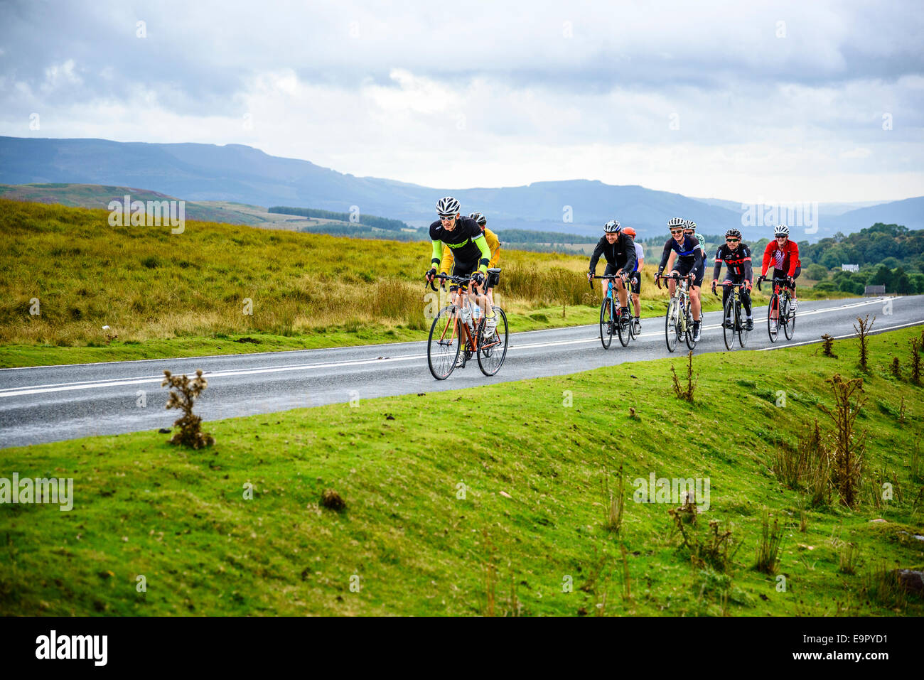 Group of cyclists on A4059 in the Brecon Beacons National Park Wales Stock Photo