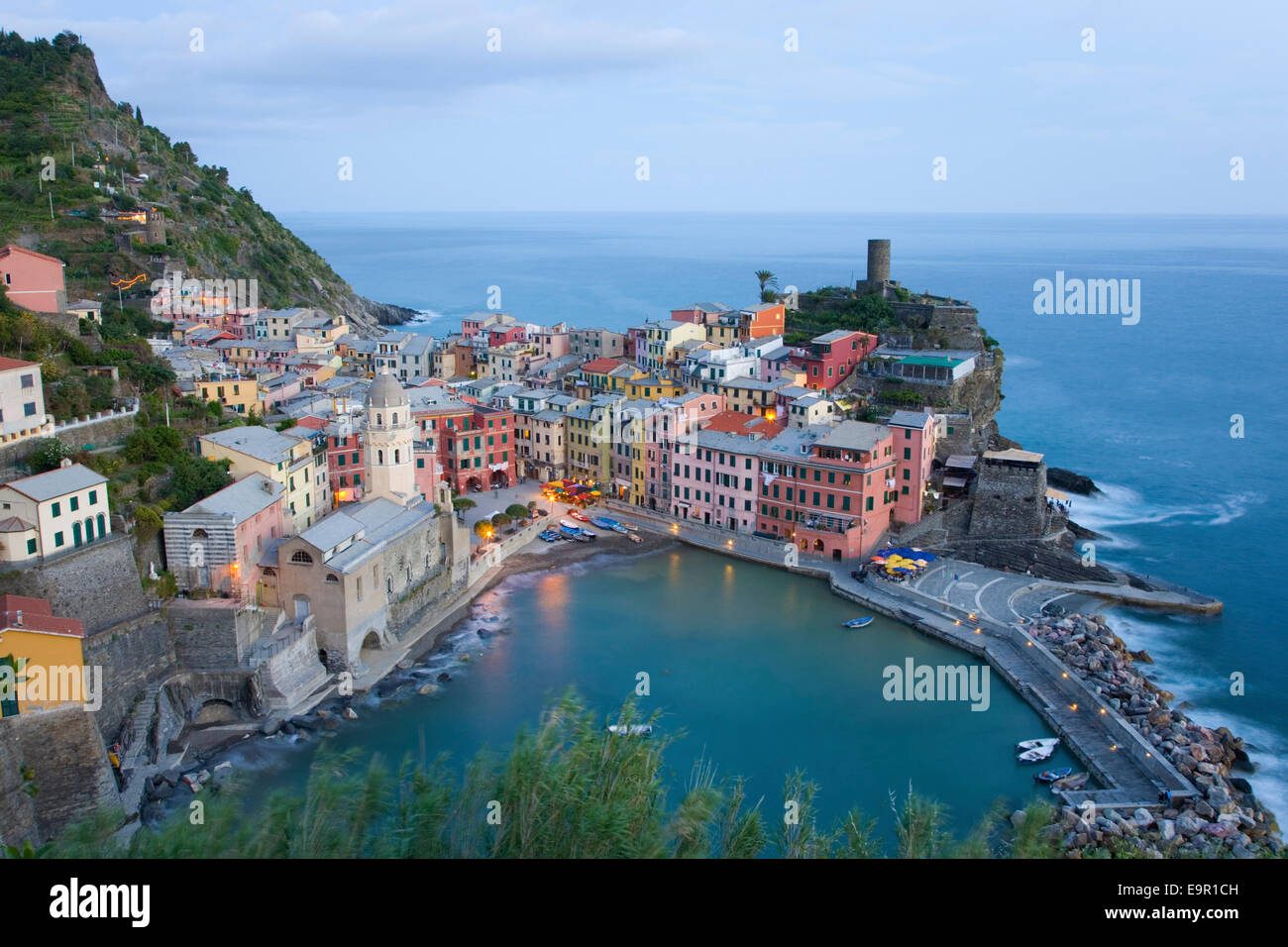 Vernazza, Cinque Terre National Park, Liguria, Italy. View over the colourful village and harbour at dusk. Stock Photo