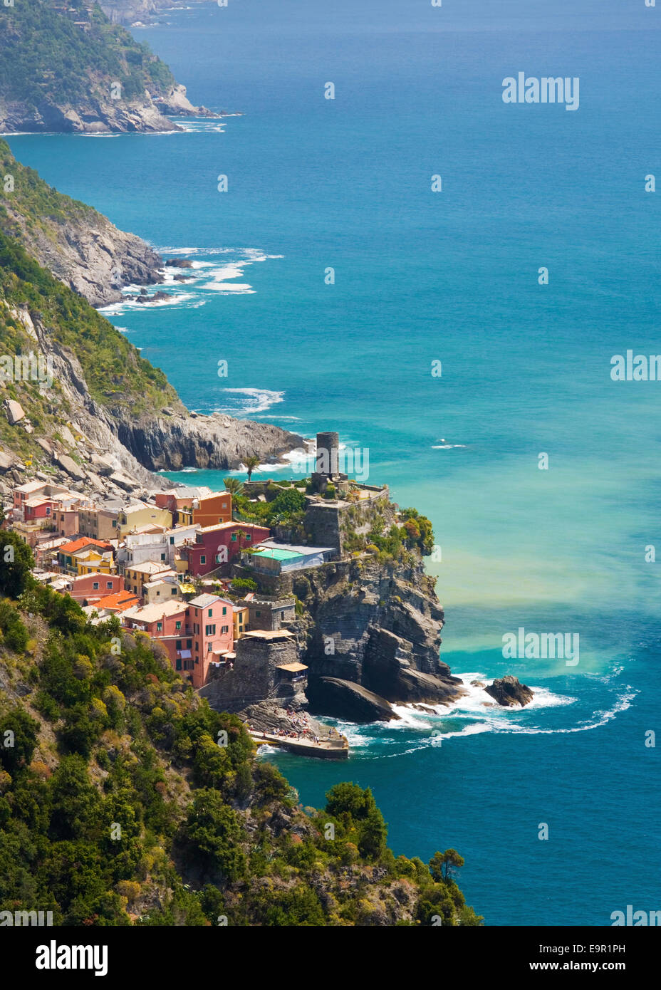 Vernazza, Cinque Terre National Park, Liguria, Italy. View to the village from footpath above rugged coast. Stock Photo