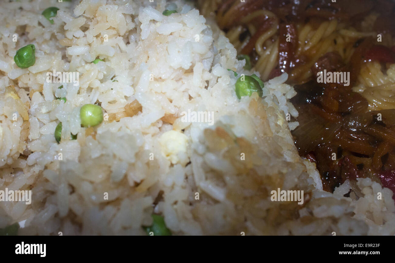 Egg fried rice with peas and Singapore noodle. Stock Photo
