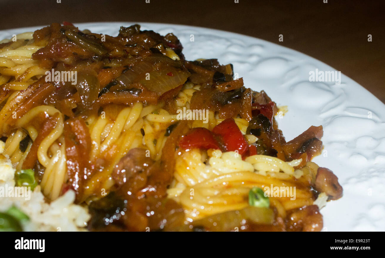 Chinese Singapore noodle on a plate with egg fried rice in the corner. Stock Photo