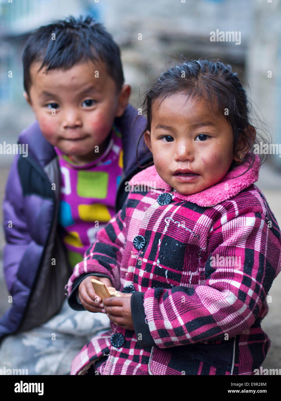Unidentified sherpa kids in Lukla village on the trail to Everest Base Camp in Nepal. Stock Photo