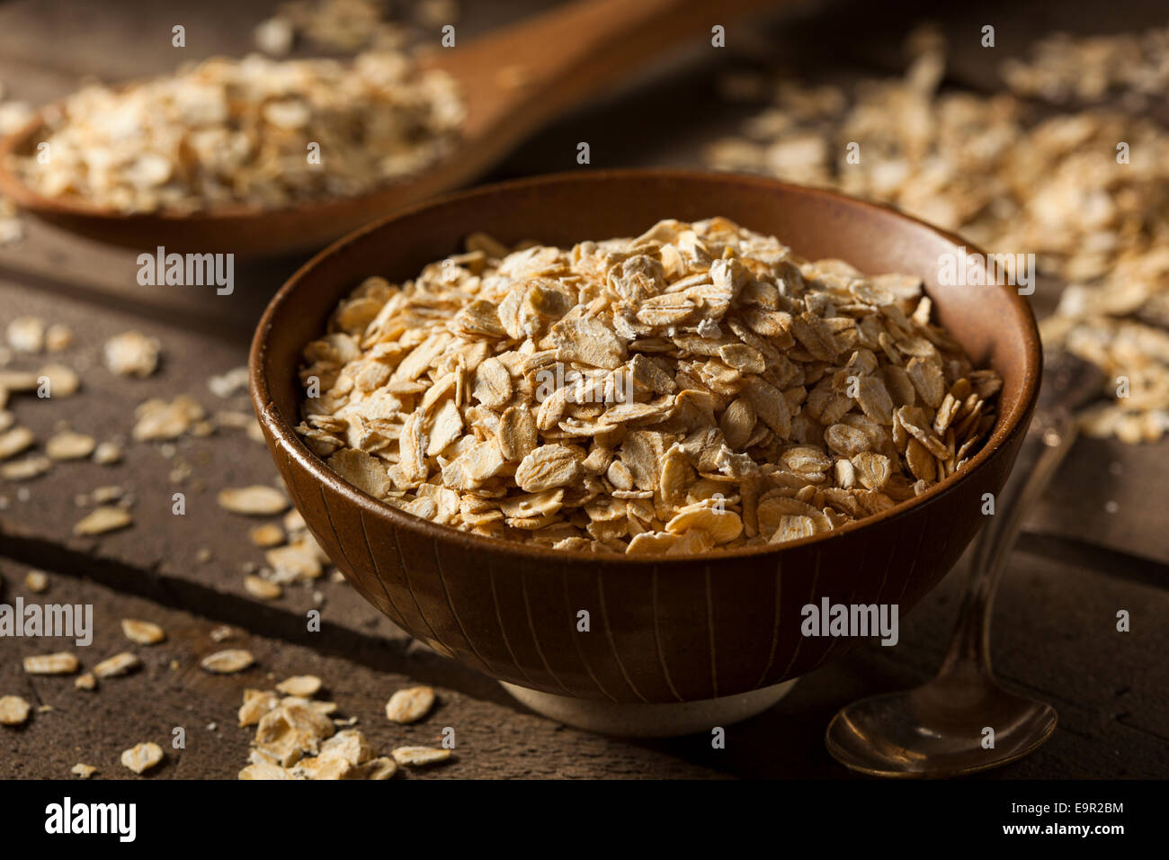 Organic Raw Dry Oats in a Bowl Stock Photo