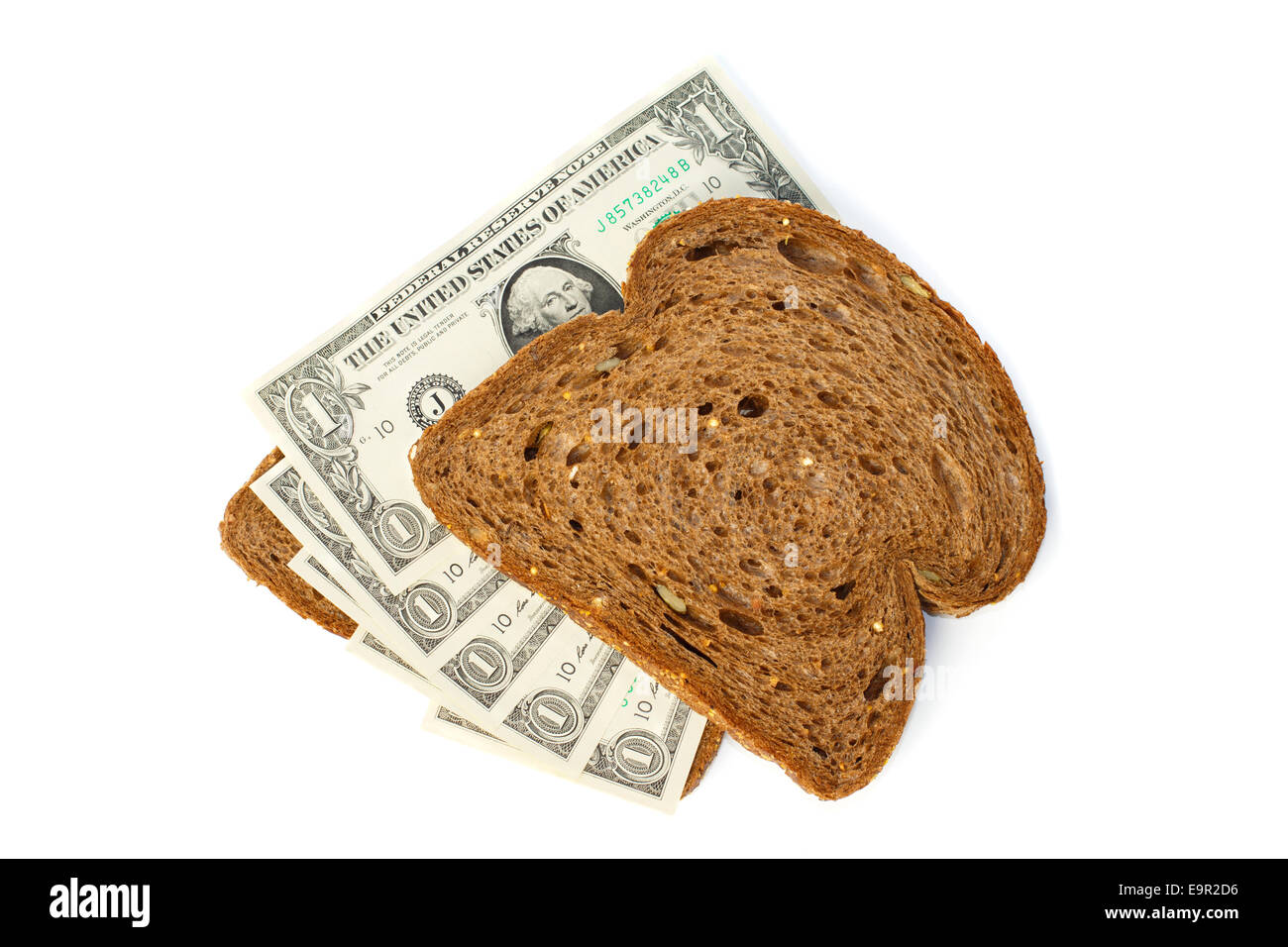 Two slices of bread topped with cash one US dollar bills Stock Photo