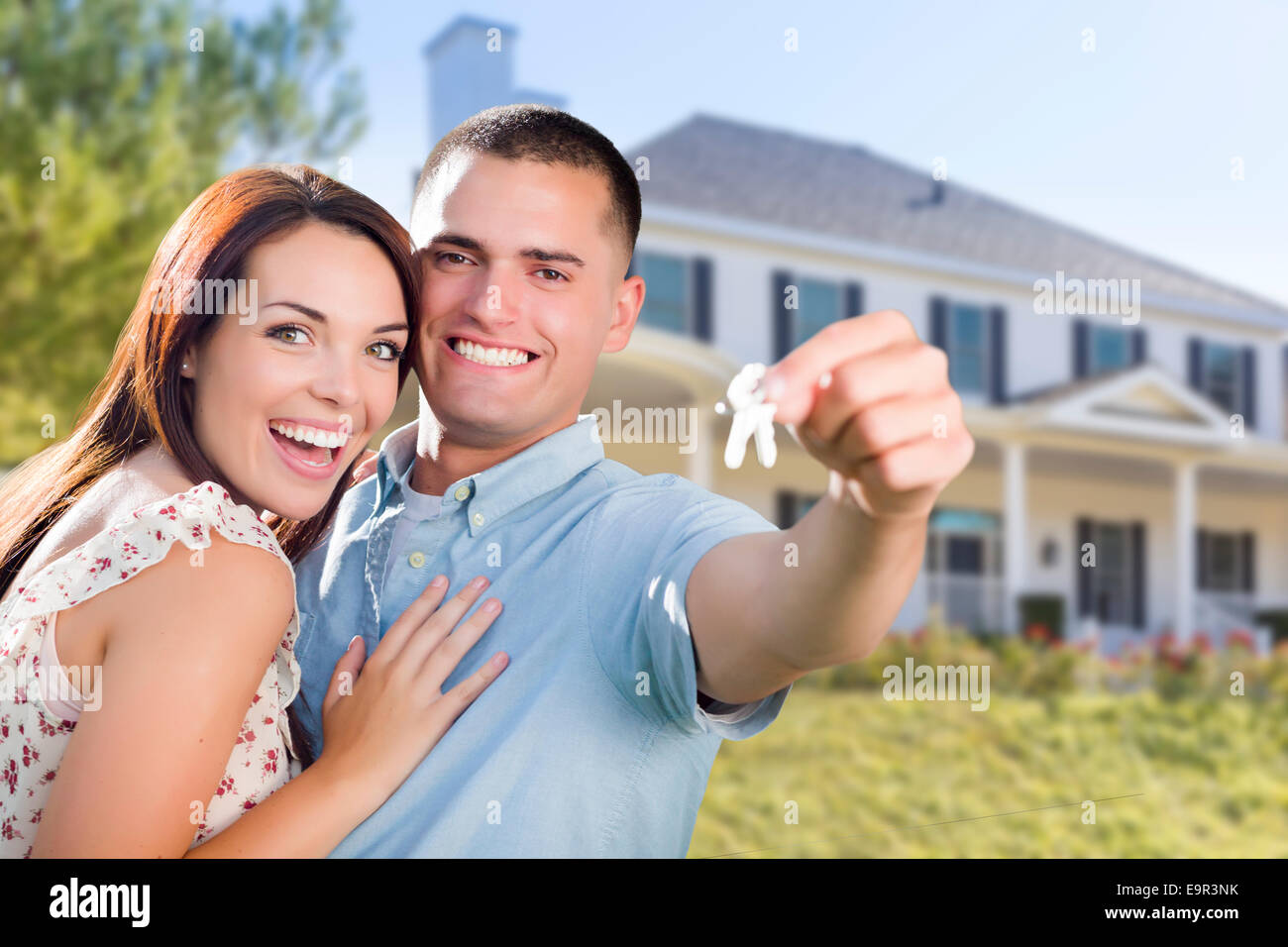 Mixed Race Excited Military Couple In Front of New Home Showing Off ...