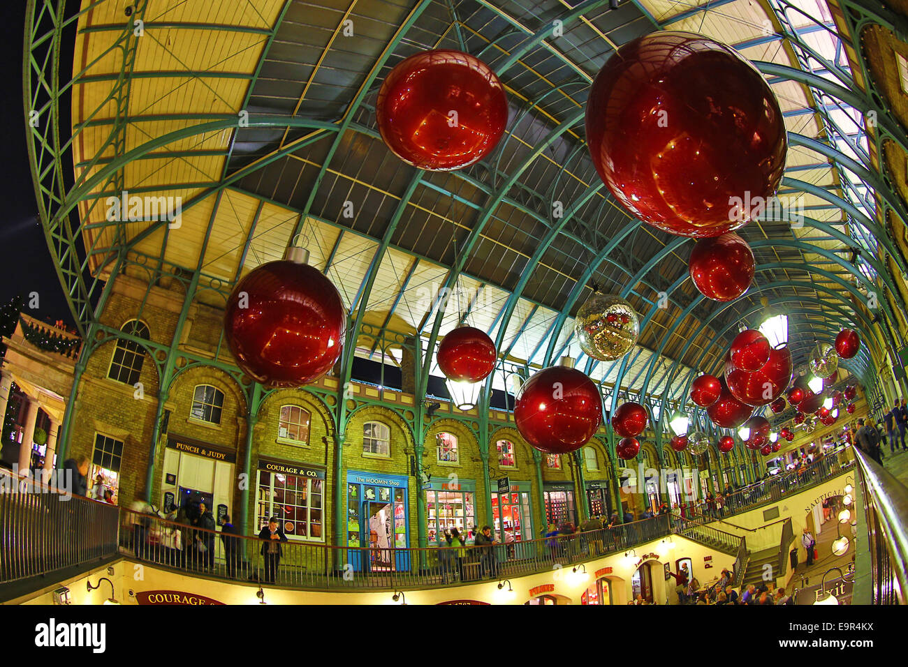 London, UK. 31st October 2014. The Covent Garden Christmas Decorations in London have gone up before the end of October although the lights won't officially be switched on until 4th November. The decorations take the form of giant red Xmas tree baubles and silver disco balls. Credit:  Paul Brown/Alamy Live News Stock Photo