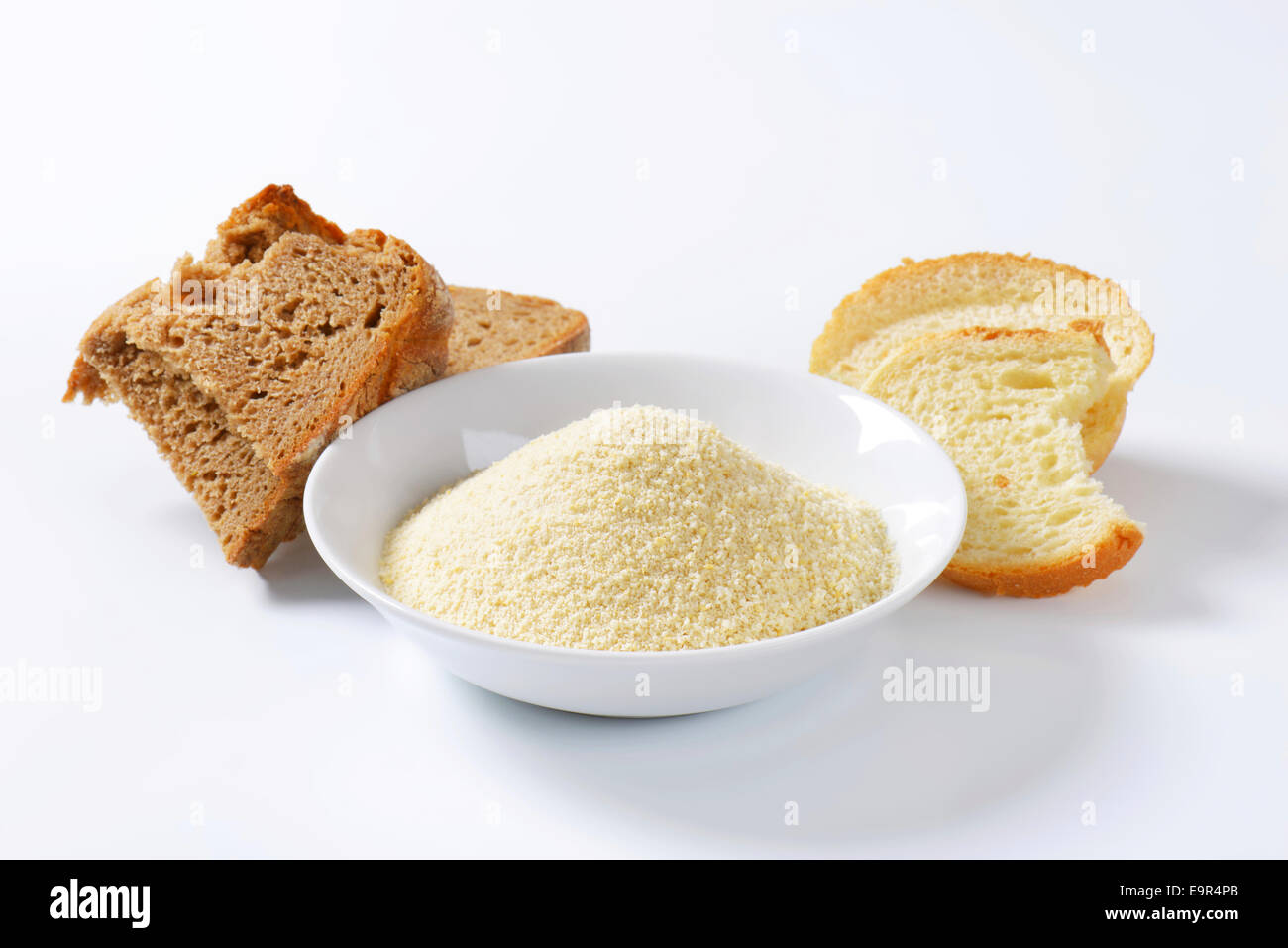 Pieces of stale bread and pile of finely ground bread crumbs Stock Photo