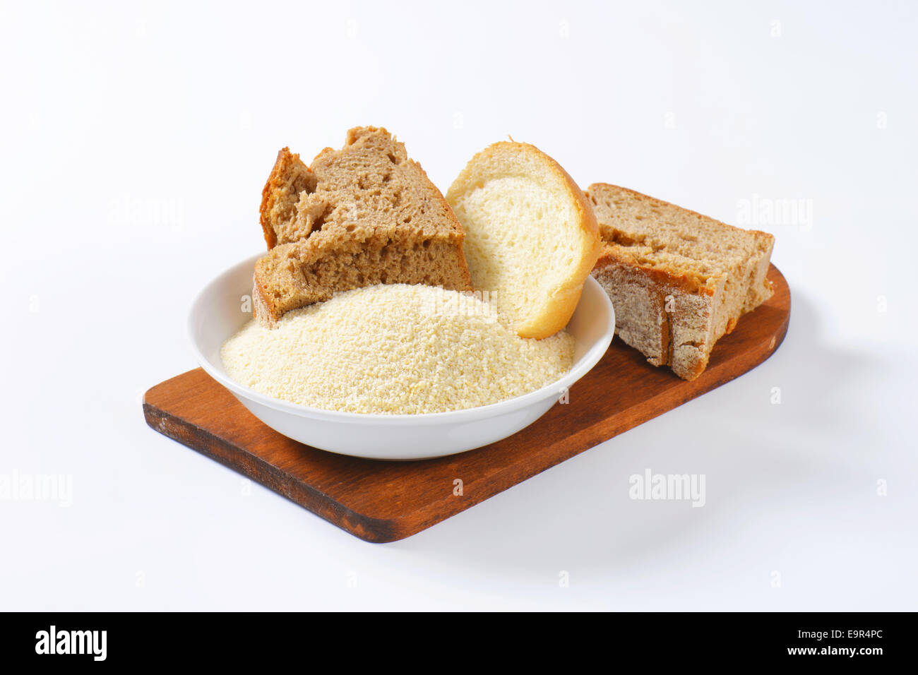 Pieces of stale bread and pile of finely ground bread crumbs Stock
