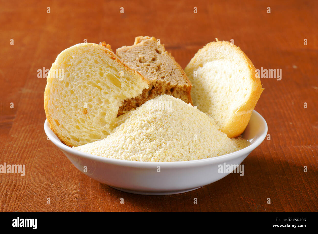 Pieces of stale bread and pile of finely ground bread crumbs Stock Photo