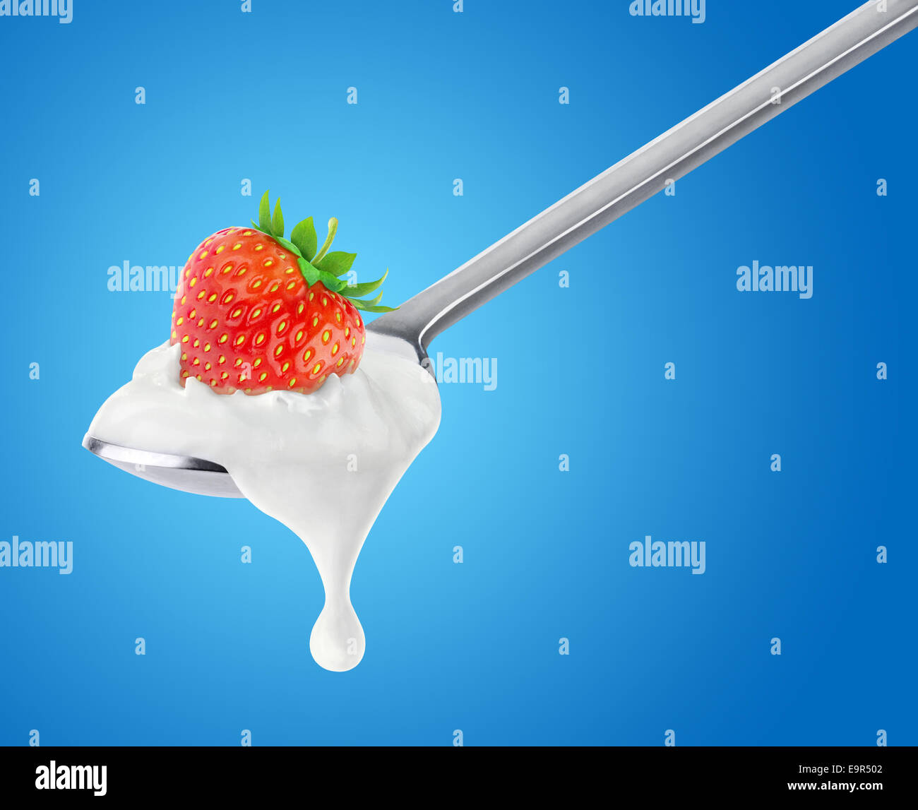 Spoon of strawberry yogurt on blue background Stock Photo