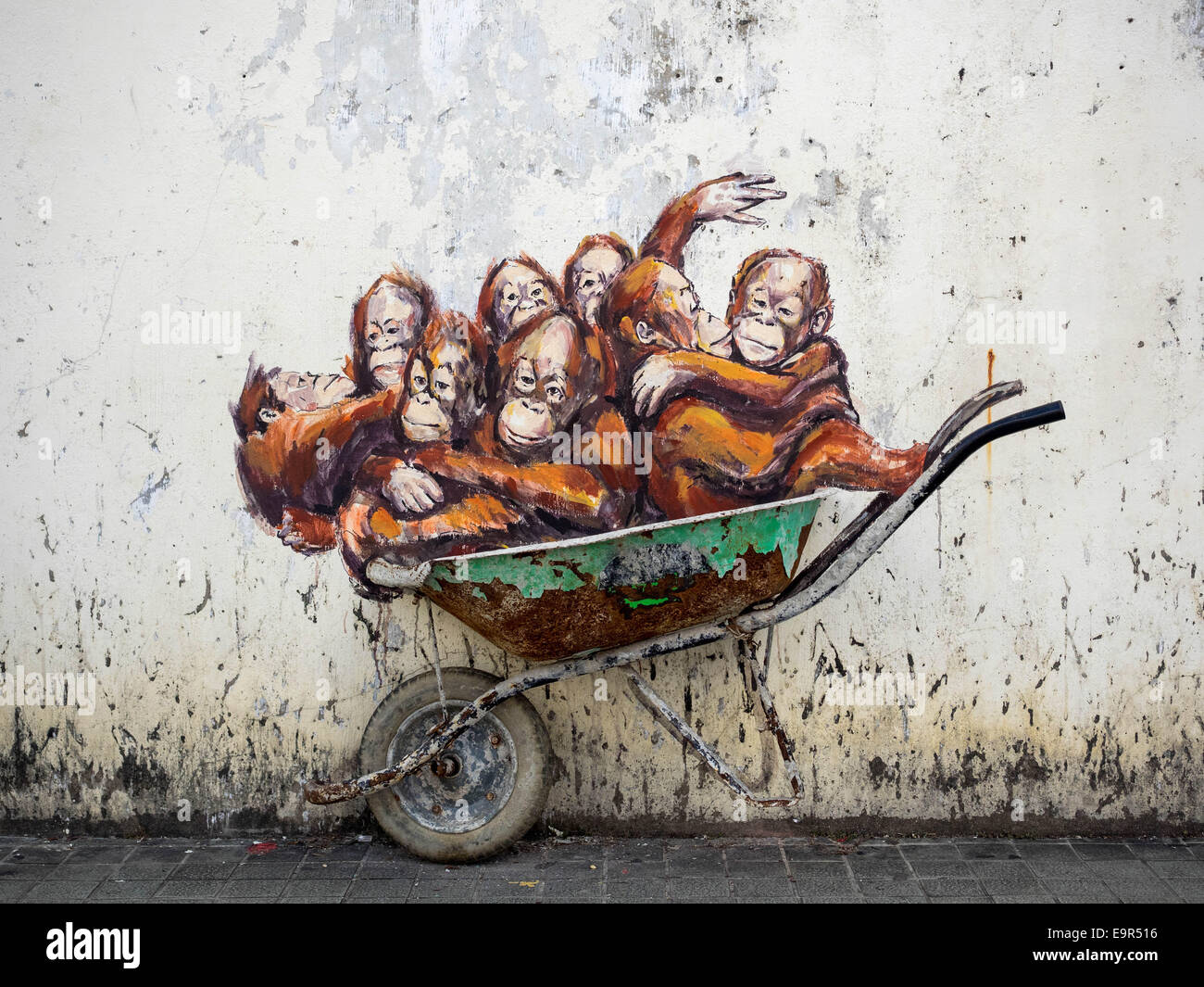 Orangutans in a Wheelbarrow street art mural by Lithuanian artist Ernest Zacharevic in Kuching, Sarawak, East Malaysia. Stock Photo