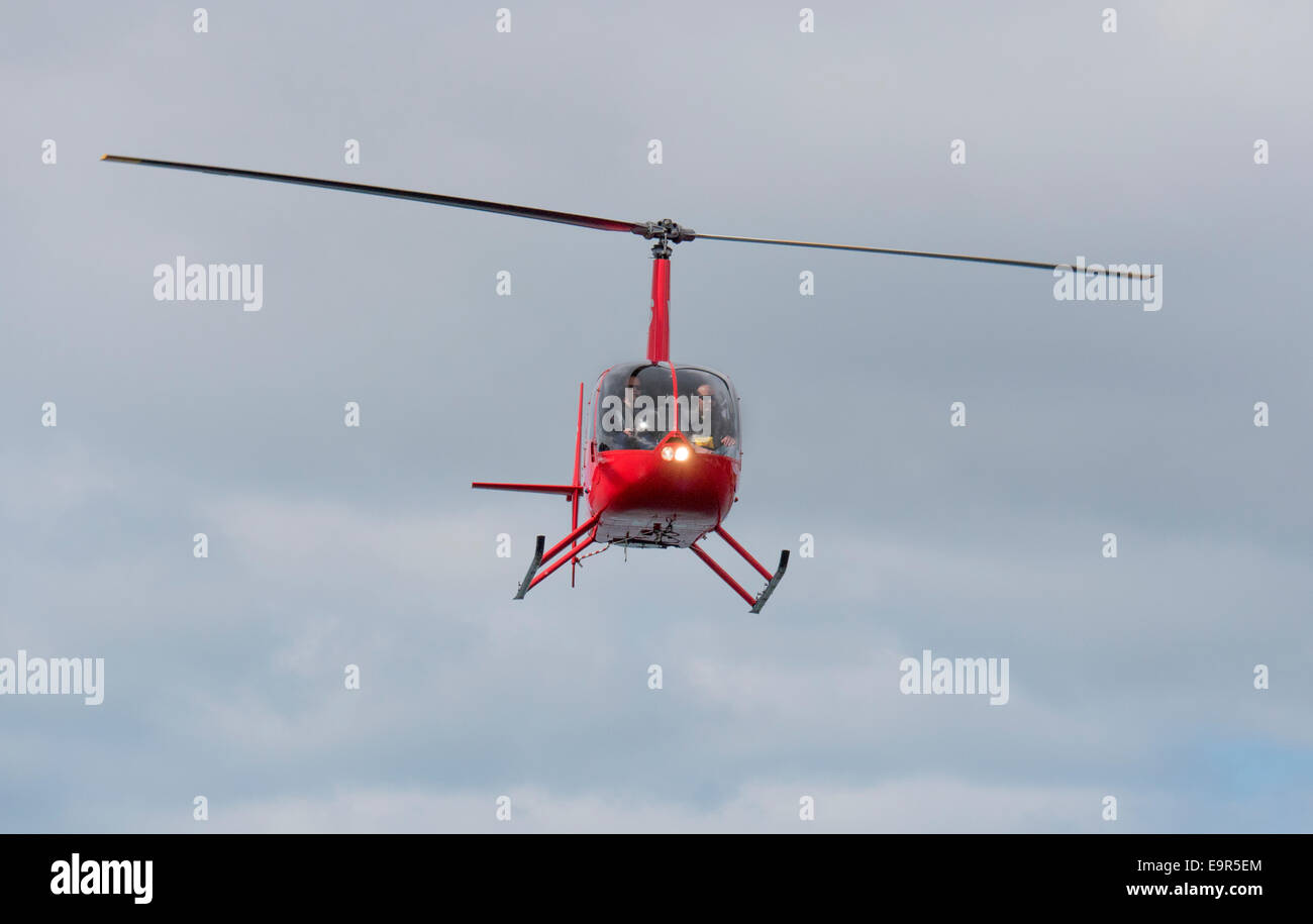 Red Helipro Robinson R22 Helicopter landing at Queens Wharf heliport ...
