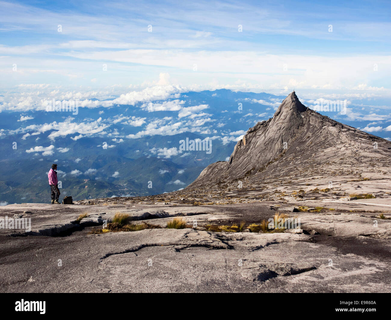 Hiker at the top of Mount Kinabalu, the highest peak in the Malay Archipelago, Sabah, East Malaysia. Stock Photo