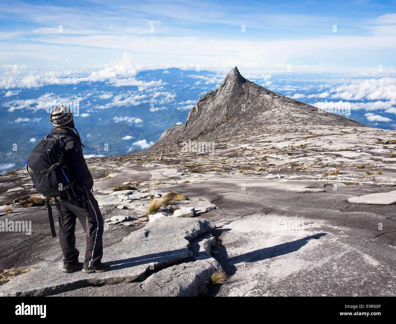 Climber at the top of Mount Kinabalu in Sabah, Malaysia. Stock Photo