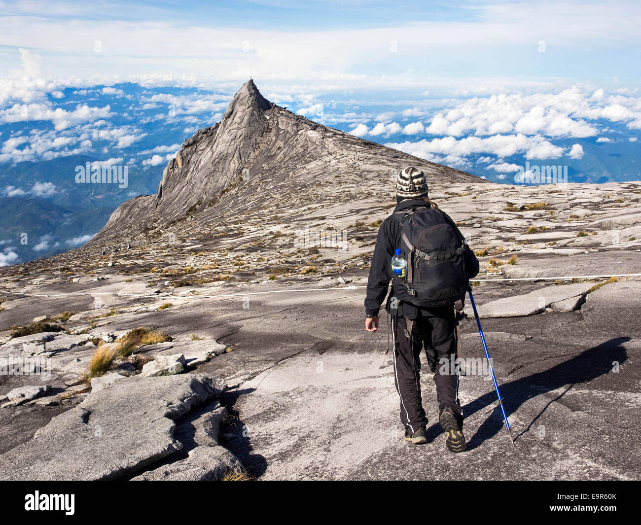 Hiker at the top of Mount Kinabalu in Sabah, East Malaysia. Stock Photo