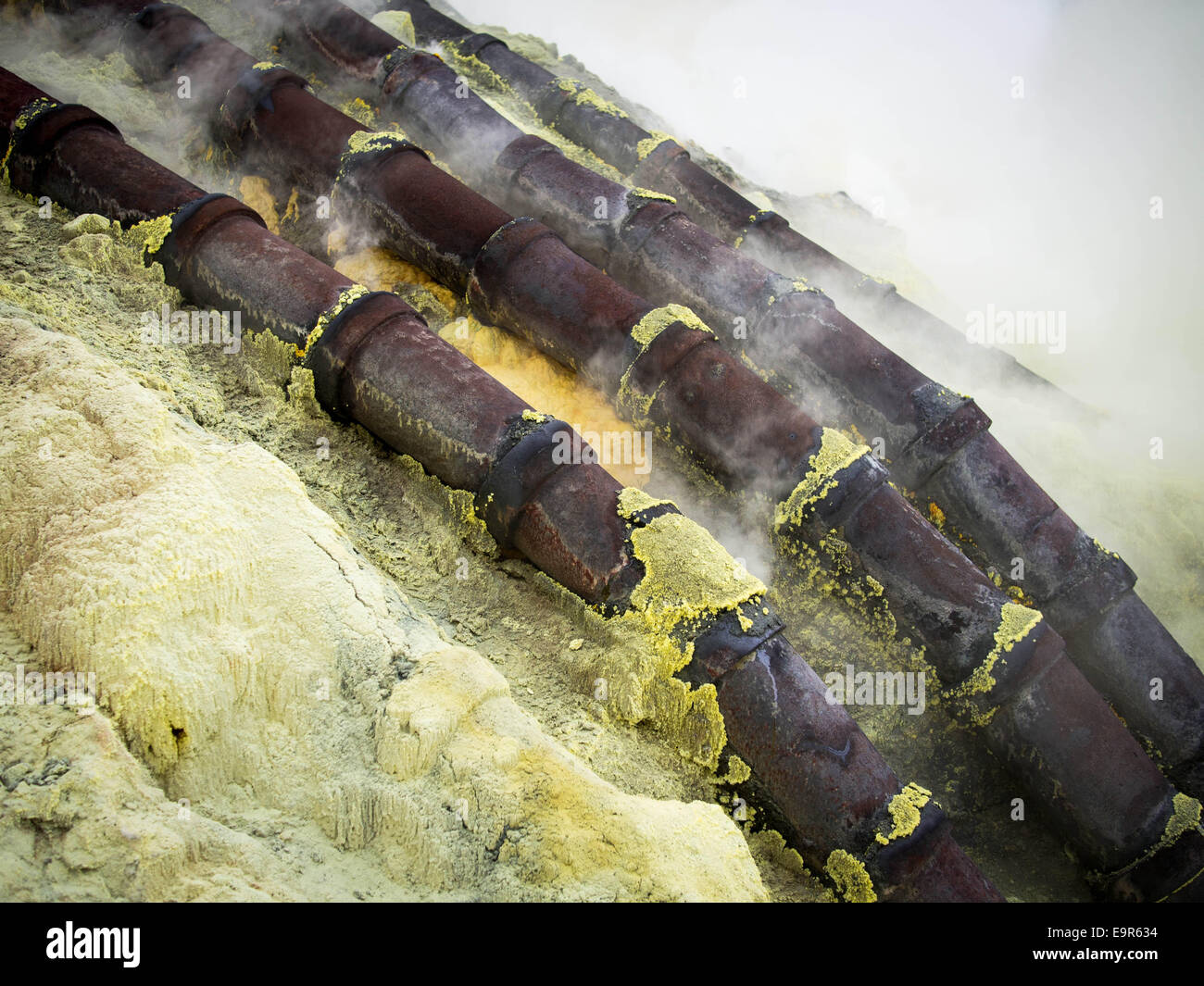 Ceramic pipes used for sulfur mining inside the crater of Kawah Ijen volcano in East Java, Indonesia. Stock Photo