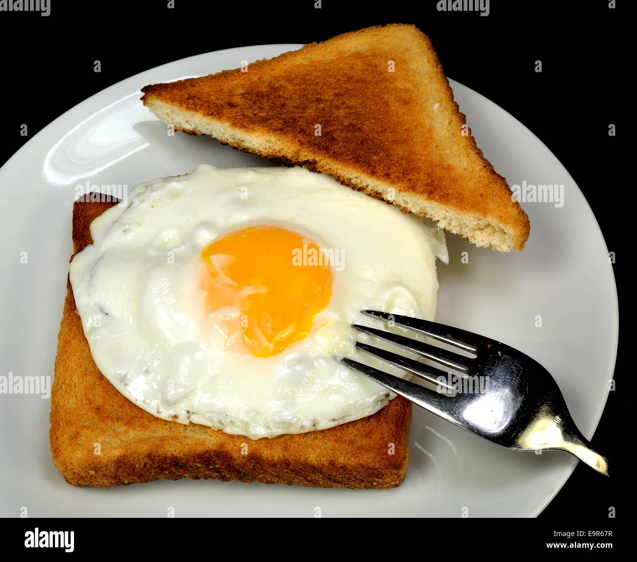 Fried egg with toast and a fork. Stock Photo