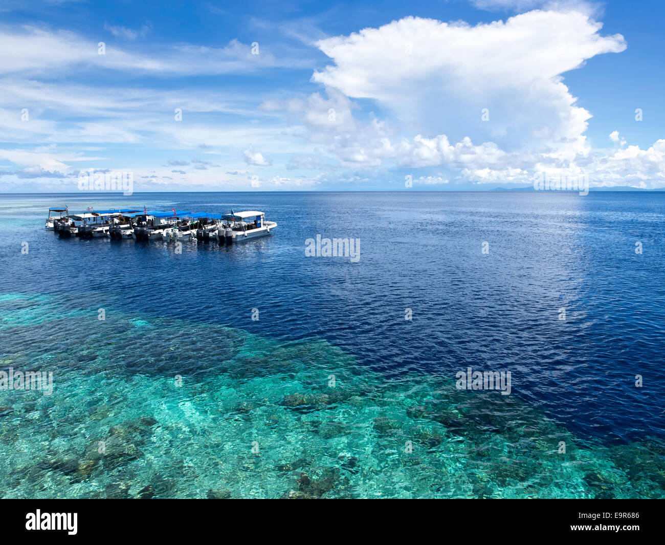 Boats at dive site off of the coast of world famous Sipadan Island in Sabah, East Malaysia. Stock Photo