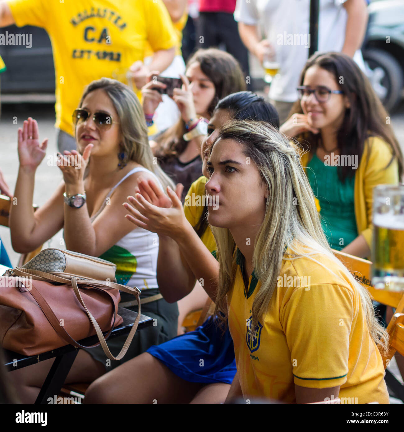 Group of Brazilian girls watching World Cup football match on TV at a bar in Salvador, Bahia, Brazil. Stock Photo