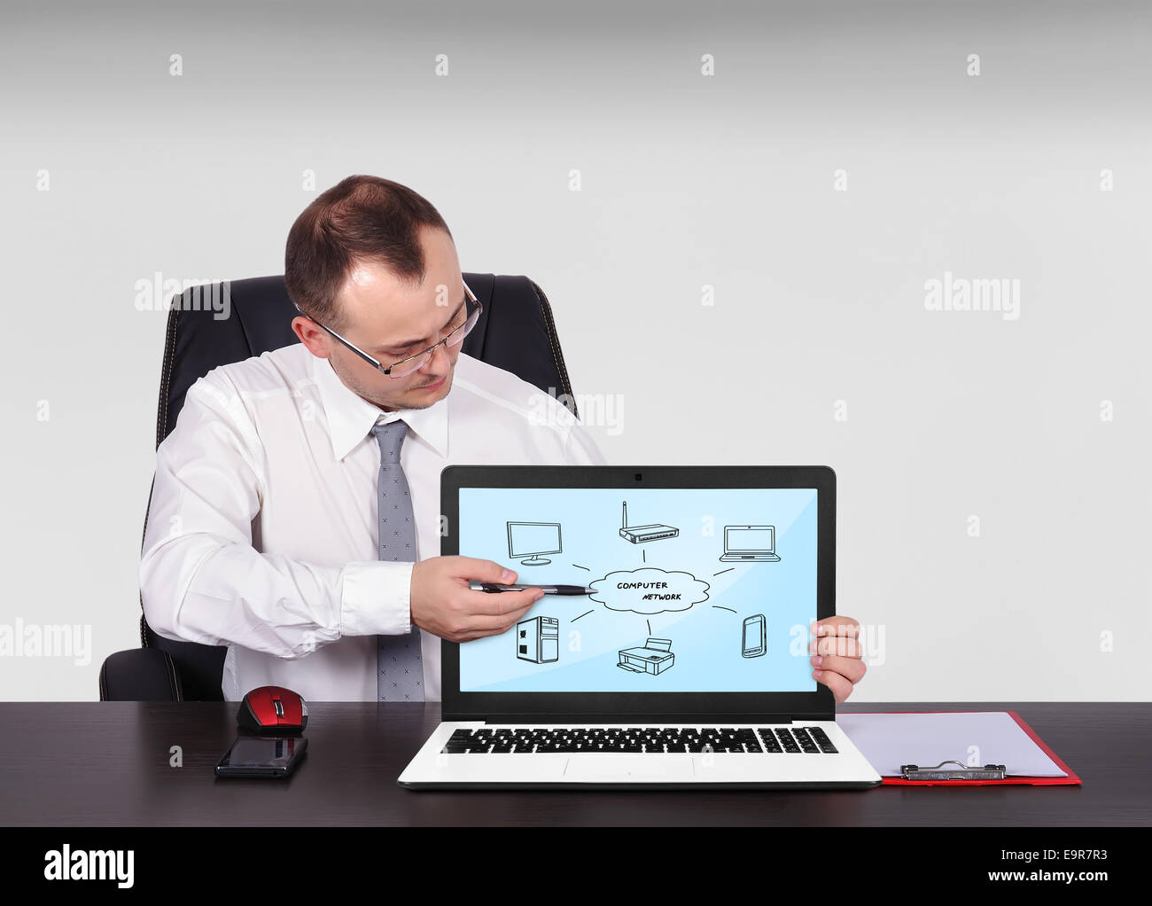 businessman pointing to screen laptop with computer network Stock Photo