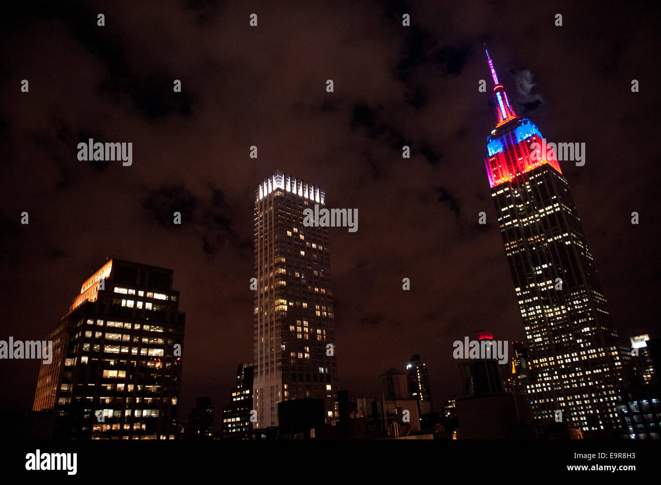 Manhattan, New York, USA. 31st Oct, 2014. The Empire State Building tower lights are lit in a show to celebrate Halloween, Friday, October 31, 3014. Credit:  Bryan Smith/ZUMA Wire/Alamy Live News Stock Photo