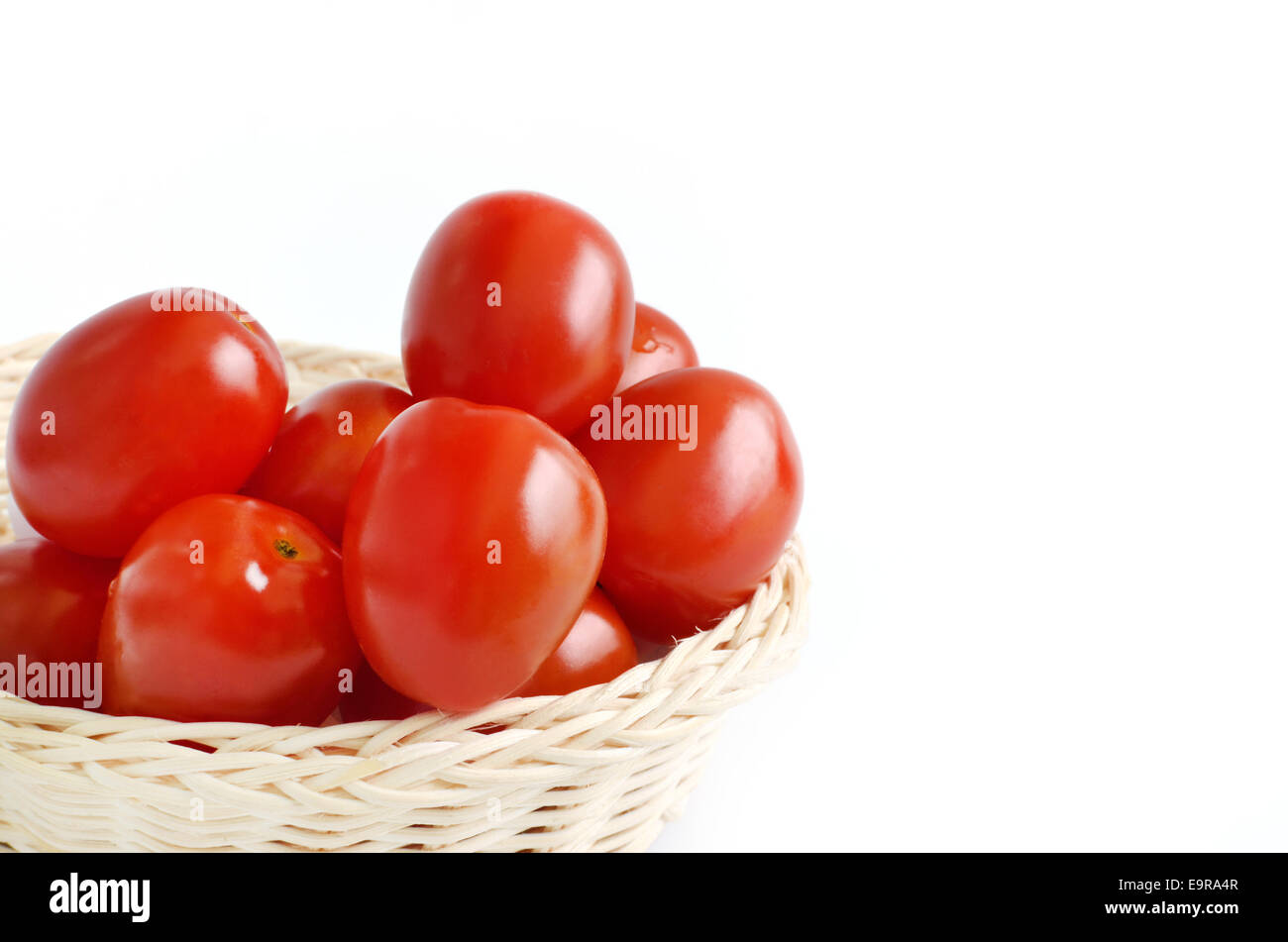 Tomatoes in basket isolated on white background Stock Photo - Alamy