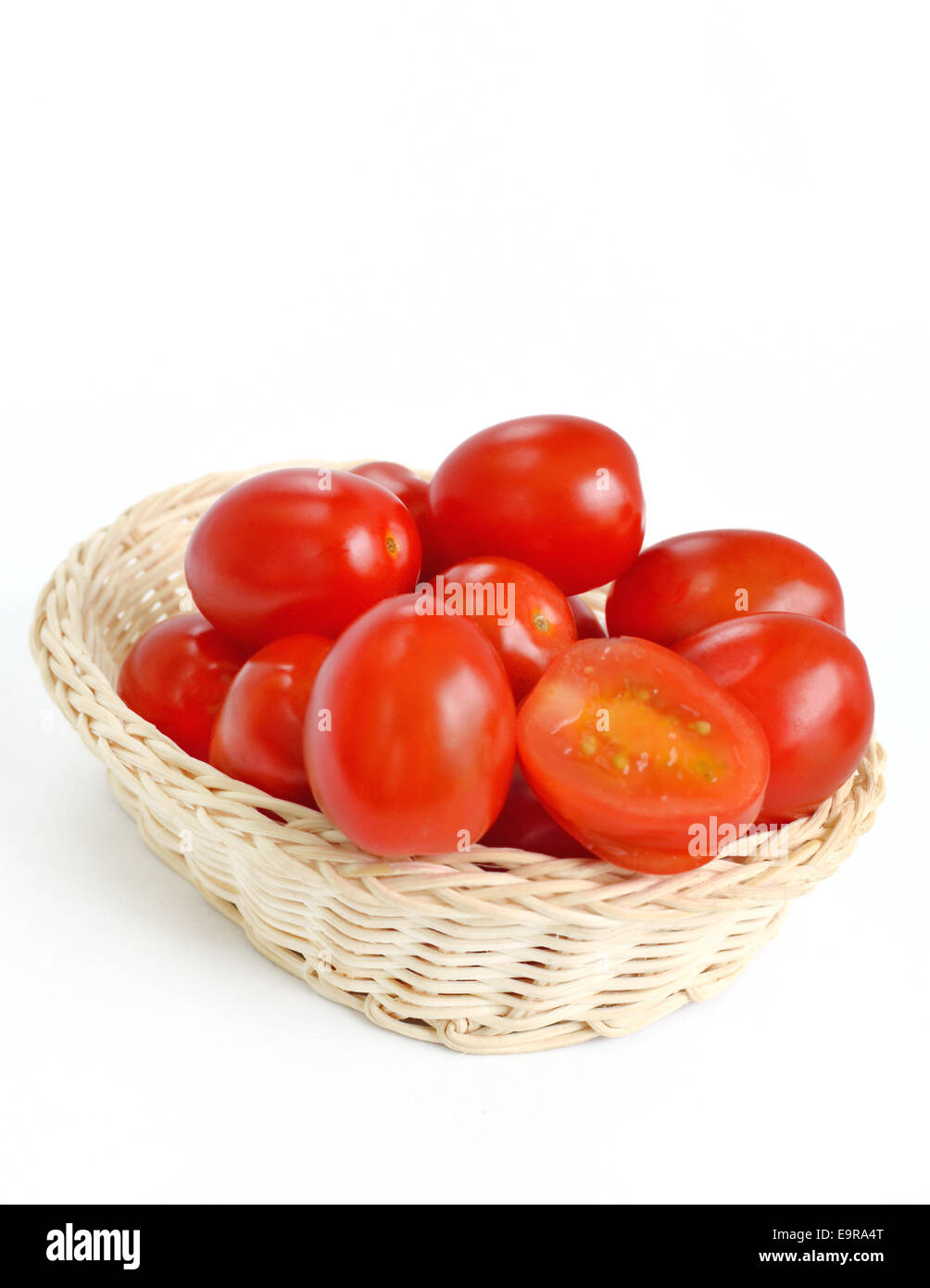 Tomatoes in basket isolated on white background Stock Photo - Alamy