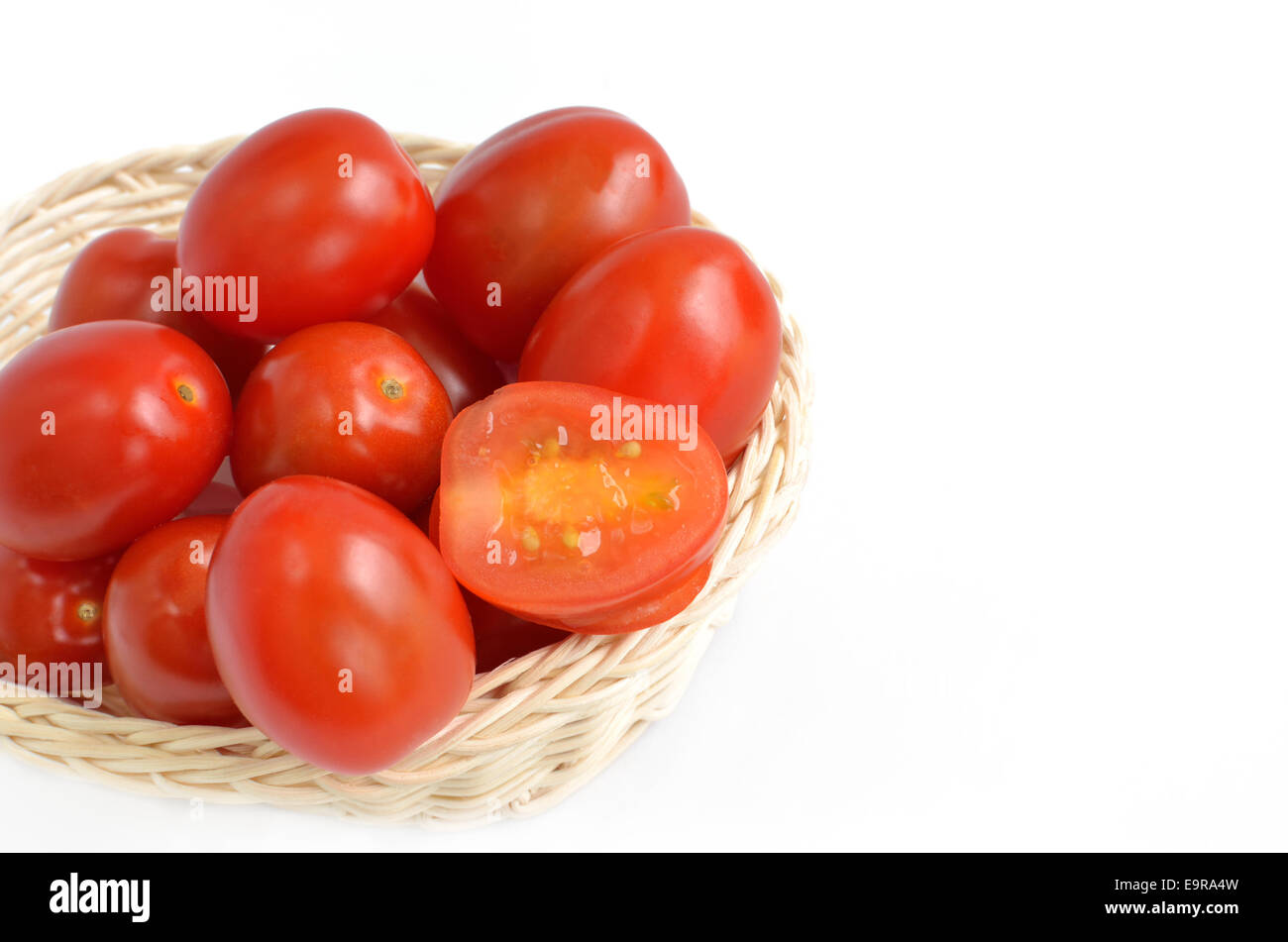 Tomatoes in basket isolated on white background Stock Photo - Alamy