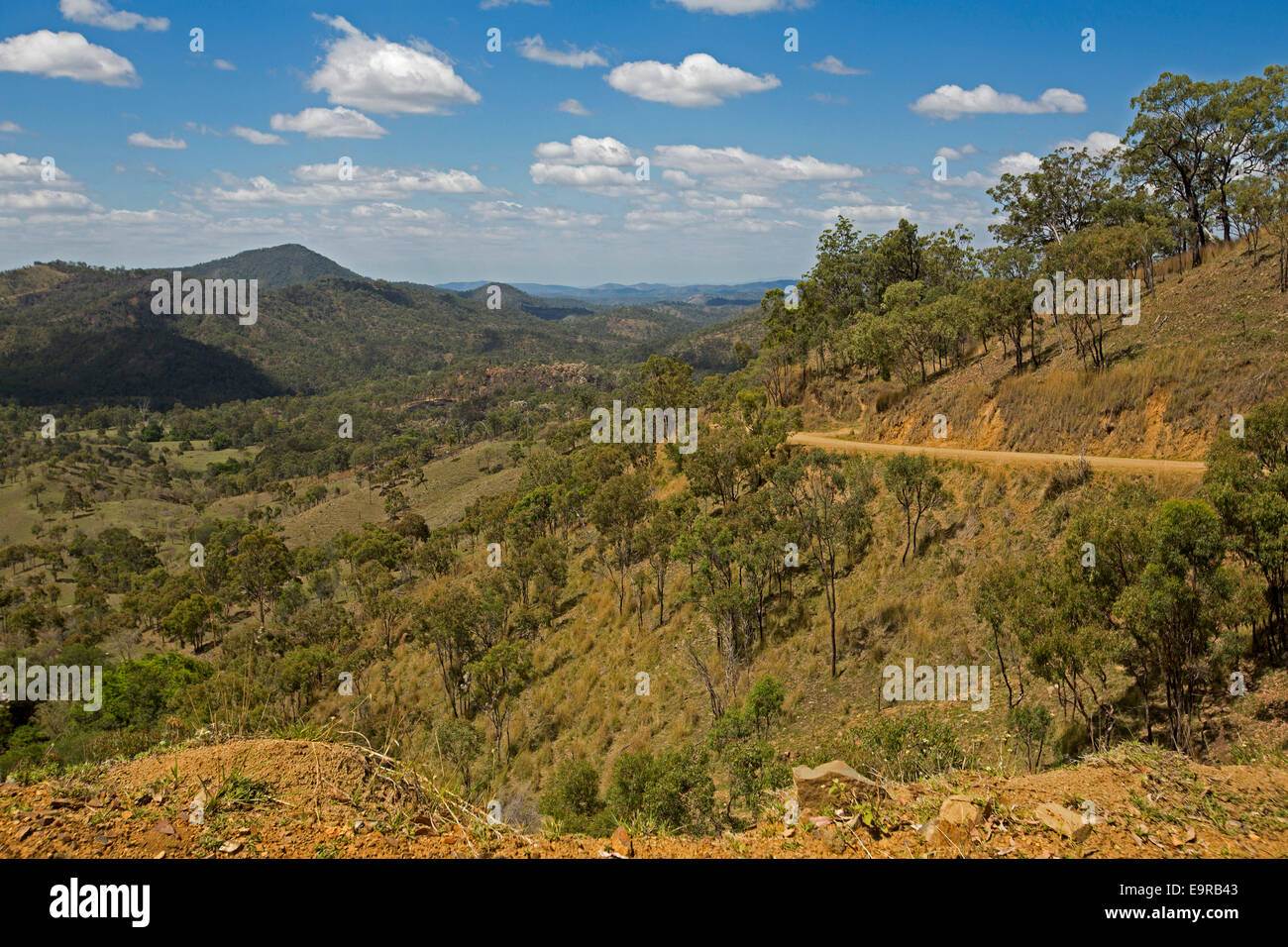 Australian landscape with extensive view of forested ranges, peaks, valleys of Great Dividing Range under blue sky Stock Photo