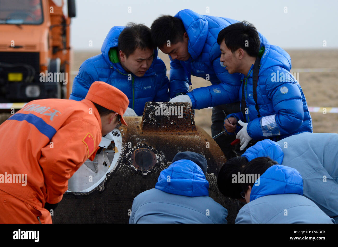 Siziwang Banner. 1st Nov, 2014. Researchers examines the return capsule of China's test lunar orbiter which lands in Siziwang Banner of north China's Inner Mongolia Autonomous Region, Nov. 1, 2014. Launched on Oct. 24, the orbiter traversed 840,000 kilometers on its eight-day mission that saw it round the far side of the Moon and take some incredible pictures of Earth and Moon together. Credit:  Ju Huanzong/Xinhua/Alamy Live News Stock Photo