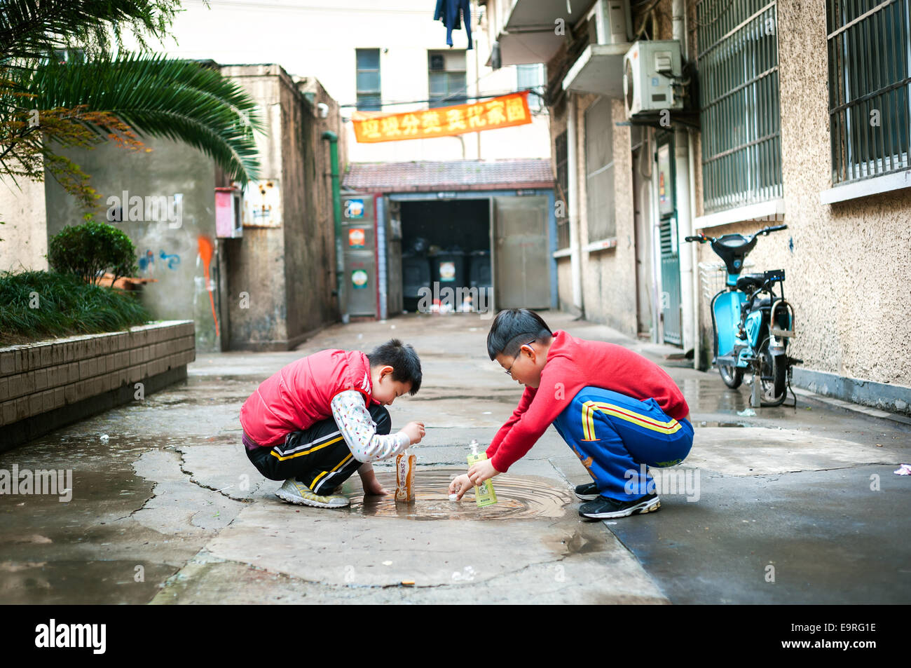 Two boys playing in a residential alley in Shanghai's old town Stock Photo