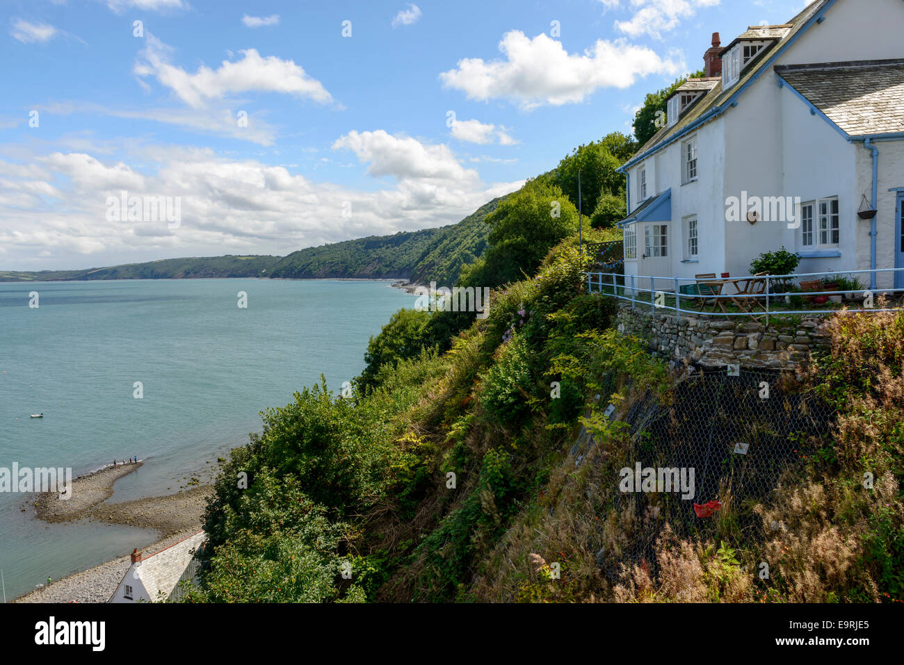 old cottage on a overhang , view of old building in historic fishing village on Devon northern coast, shot in bright light Stock Photo