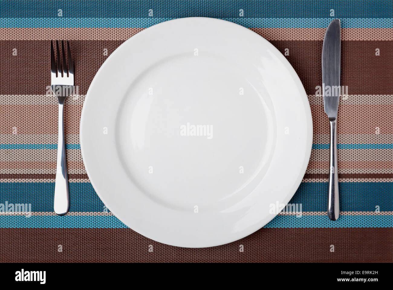 Knife, Fork and plate on table Stock Photo - Alamy