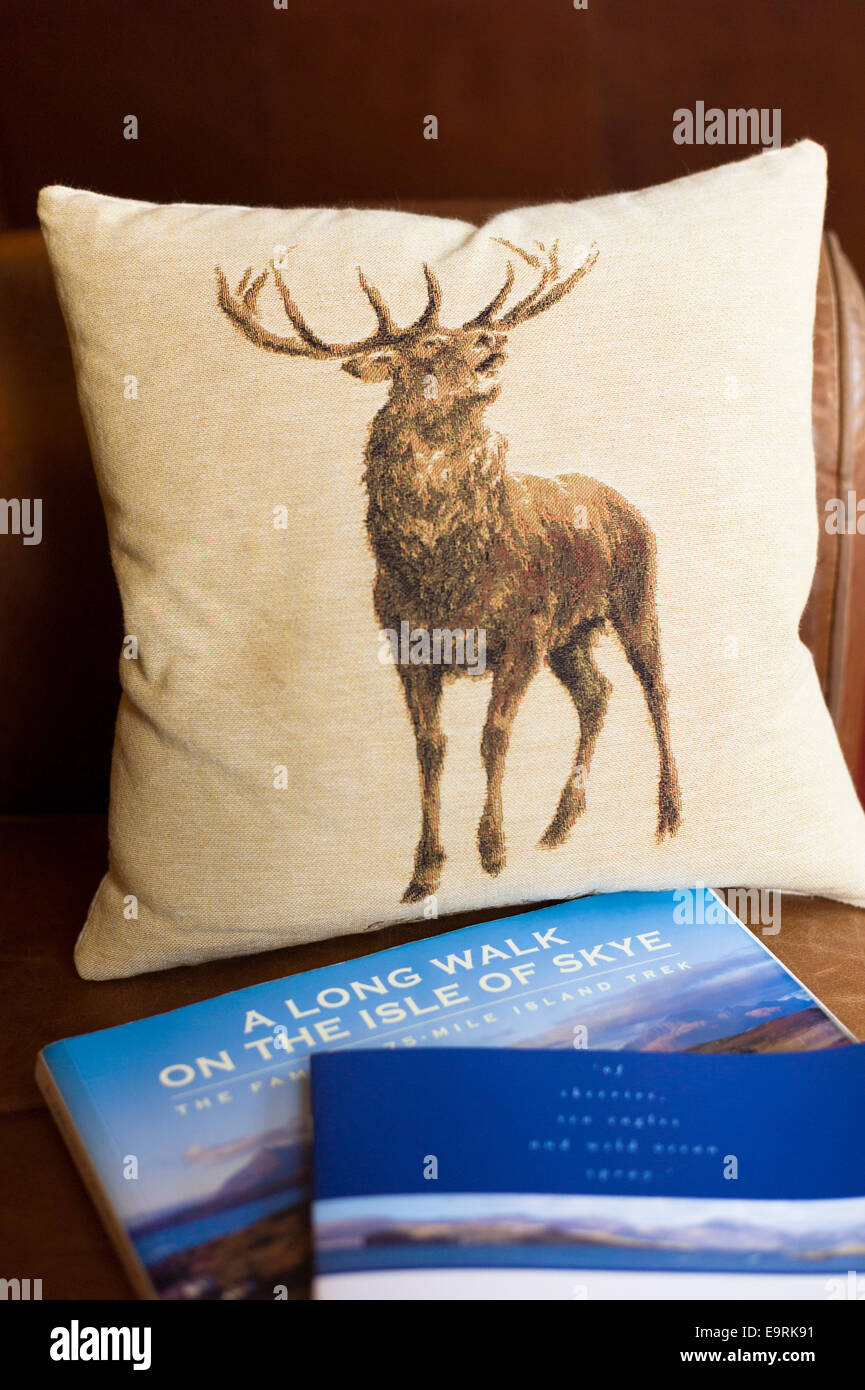 Red deer cushion and country walks guide book at luxurious Ullinish Lodge Hotel at Struan, Isle of Skye, Western Isles of Scotla Stock Photo