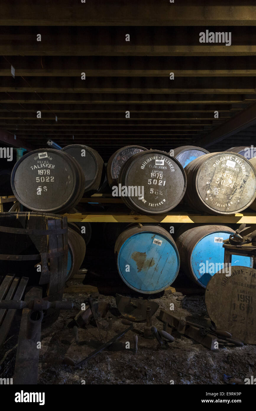 Single malt Scotch Whisky in oak casks - barrels - in traditional dunnage warehouse during maturation process at Talisker Distil Stock Photo