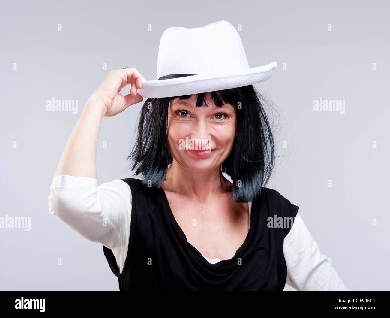 Portrait of a Woman with Black Wig and White Hat Stock Photo