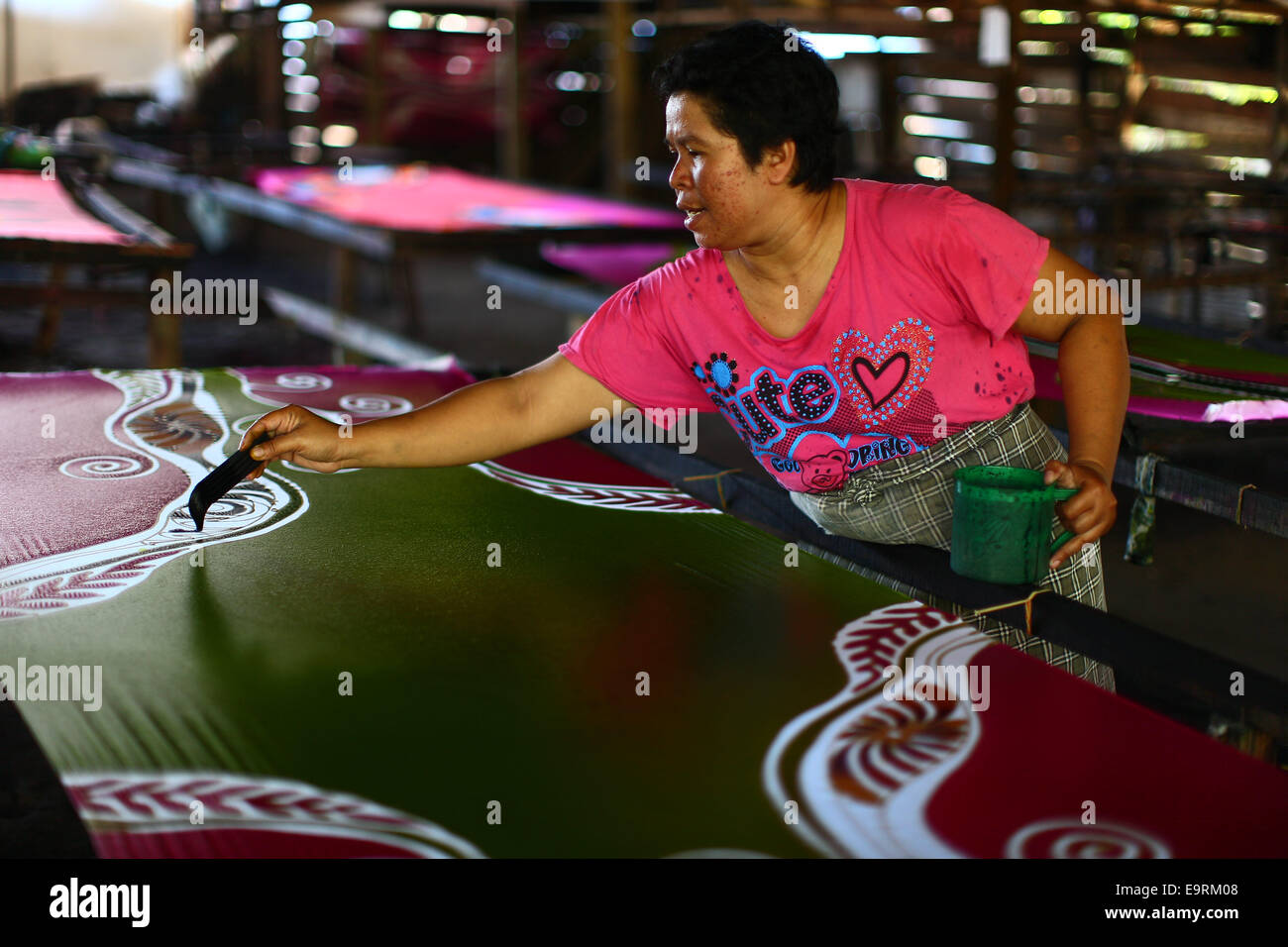 Preparing the melting wax for Batik Chanting traditional painting. Stock Photo