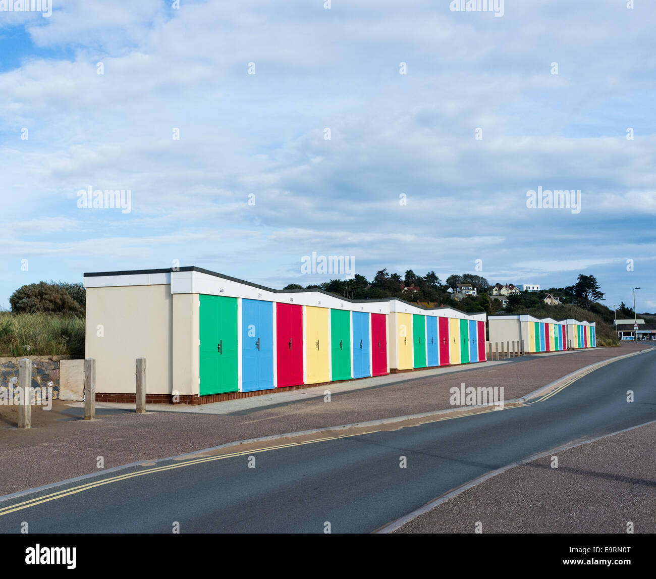 A row of very colorful beach huts on Exmouth sea front. Yellow, red, blue and green. Stock Photo